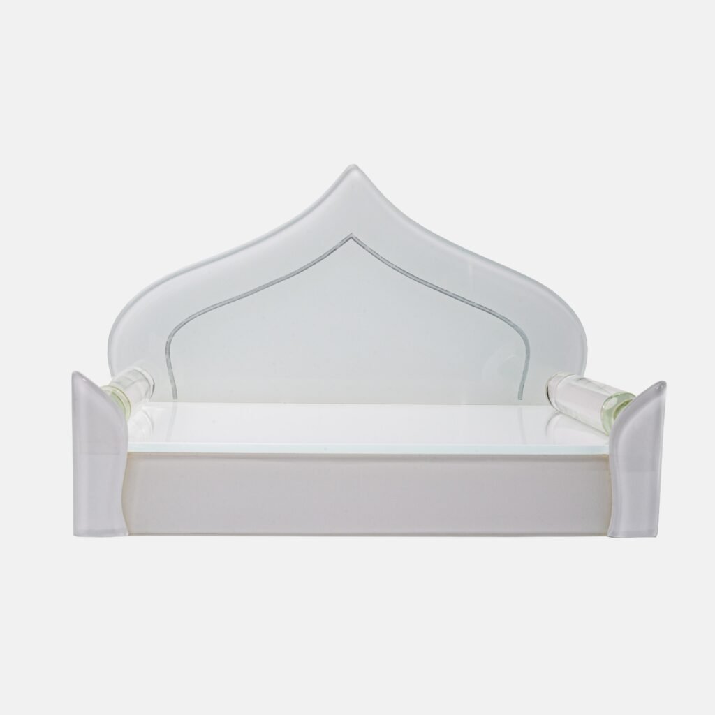 Elegant all-white glass devpaat with a dome-shaped backrest and subtle mirror trim, designed for a modern home temple by Creata Poojaghar.