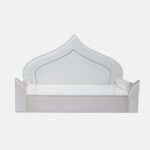 Elegant all-white glass devpaat with a dome-shaped backrest and subtle mirror trim, designed for a modern home temple by Creata Poojaghar.