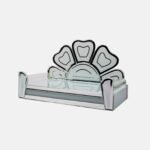 Modern glass devpaat with a stylized lotus petal backrest and reflective mirror borders on a frosted glass base, handcrafted by Creata Poojaghar.